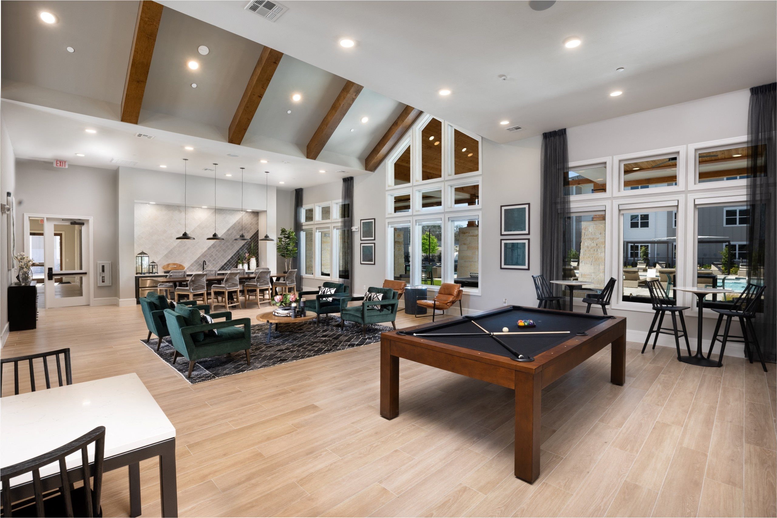 an open living room with a pool table and a dining room